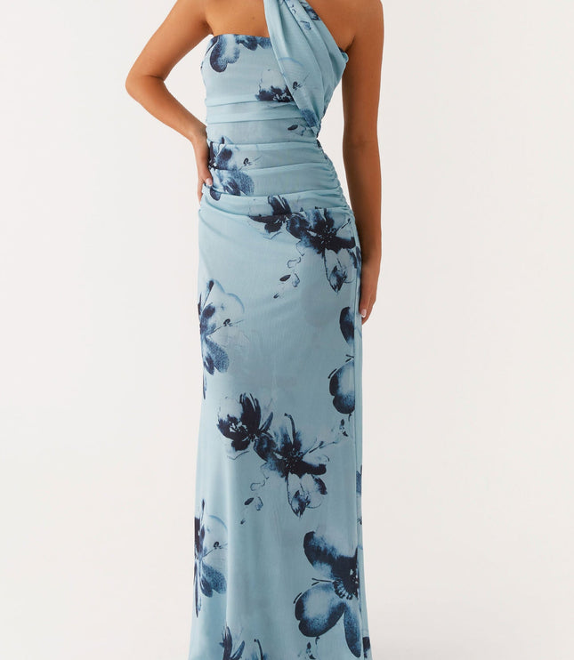 Light blue floral strapless ruched maxi dress with a hand on hip pose, emphasizing the fit and dark blue flower print.
