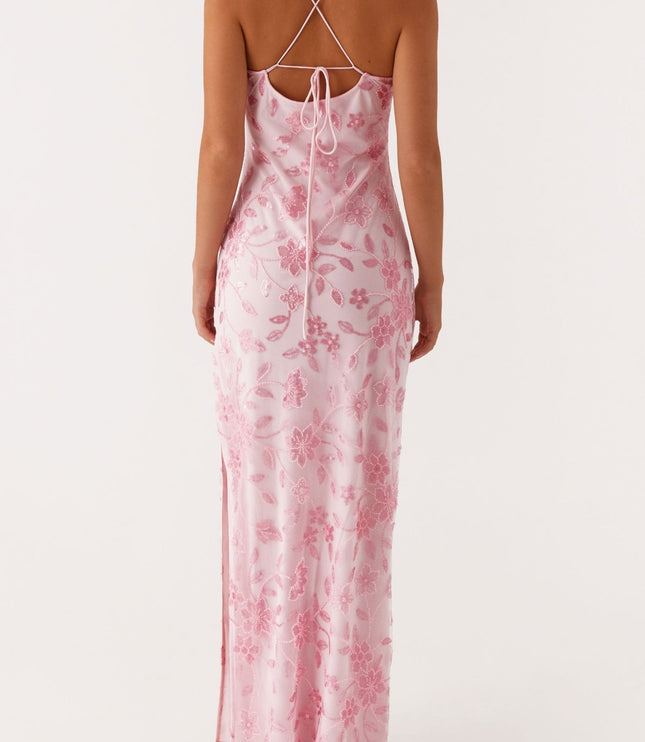 Back view of a pink floral maxi dress showing the tie-back detail and delicate beading on the fabric.