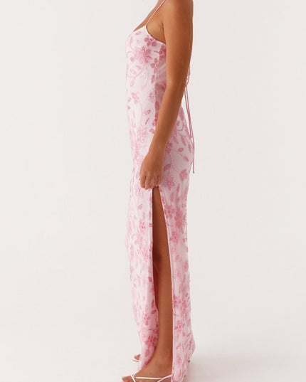 Side profile of the pink floral maxi dress, highlighting the high side slit and delicate spaghetti straps.