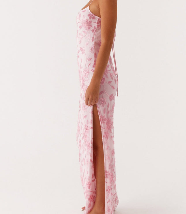 Side profile of the pink floral maxi dress, highlighting the high side slit and delicate spaghetti straps.