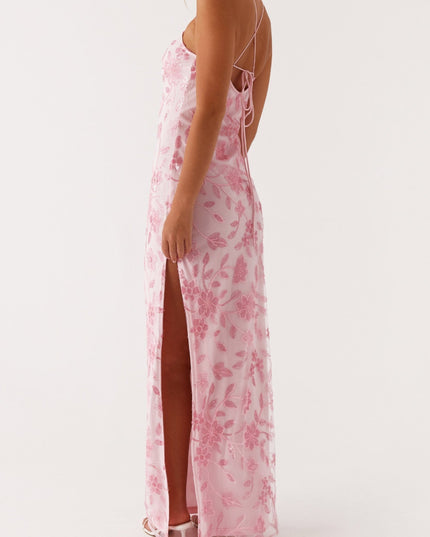 Three-quarter back view of the pink floral maxi dress, showing the tie-back and a side slit.
