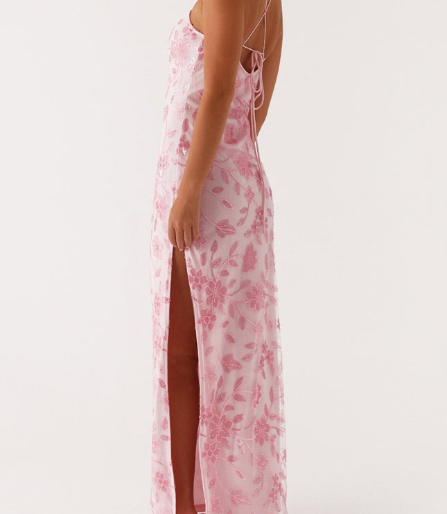 Three-quarter back view of the pink floral maxi dress, showing the tie-back and a side slit.