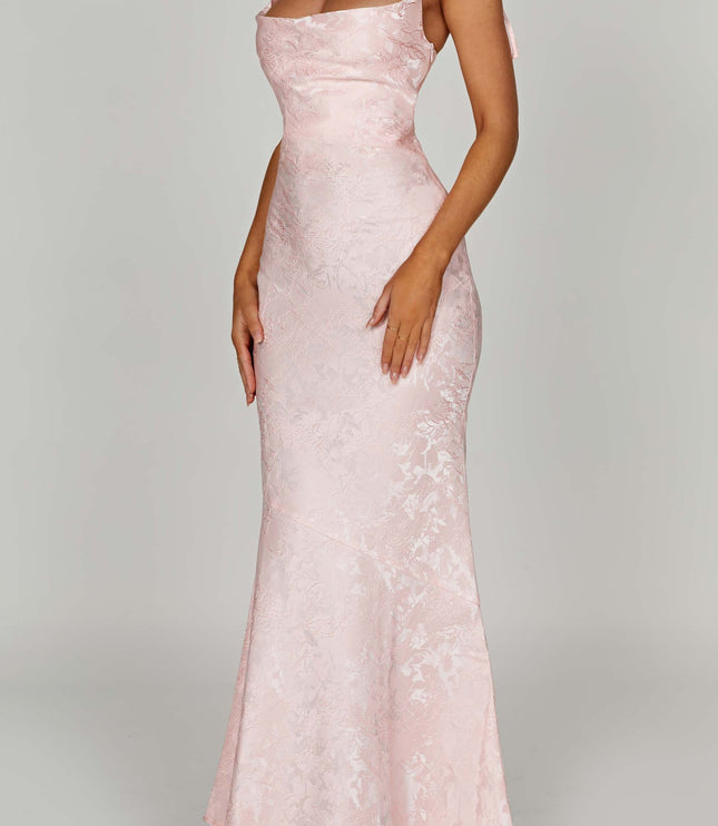 Side profile of the women's pink floral maxi dress, showing the elegant cut and tie-shoulder details.