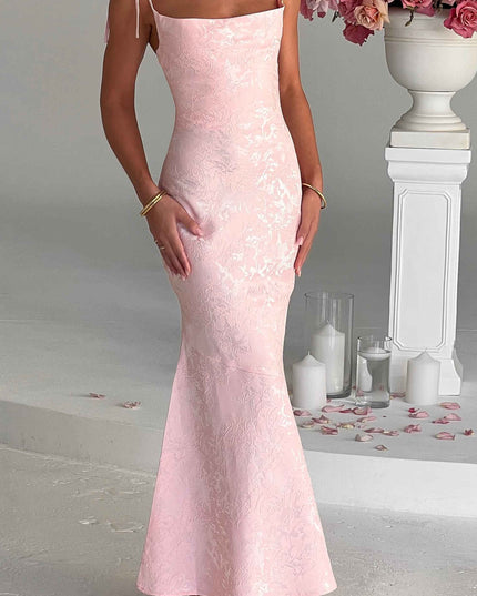 Front view of a women's pink floral maxi dress with delicate tie straps and a fitted silhouette, for special occasions.