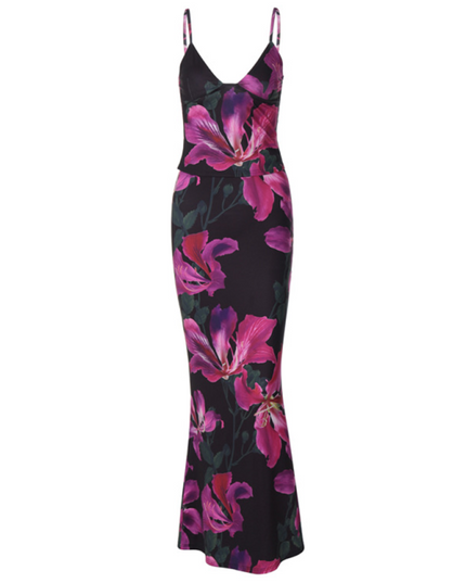 Full view of women's floral maxi dress in black with striking pink and purple flower pattern, fit.