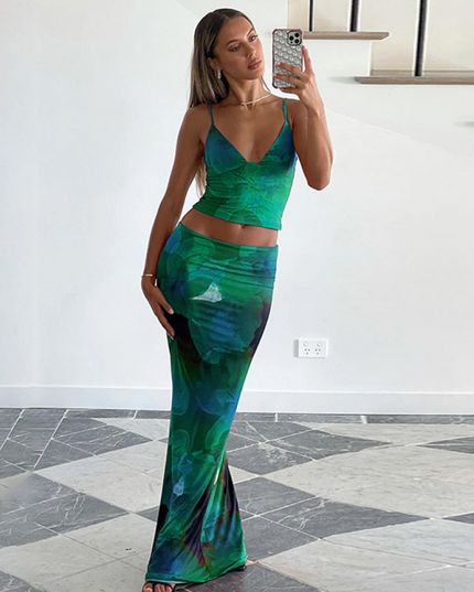 Women's green floral V-neck crop top and maxi skirt set, full length, with a green and blue flower print.