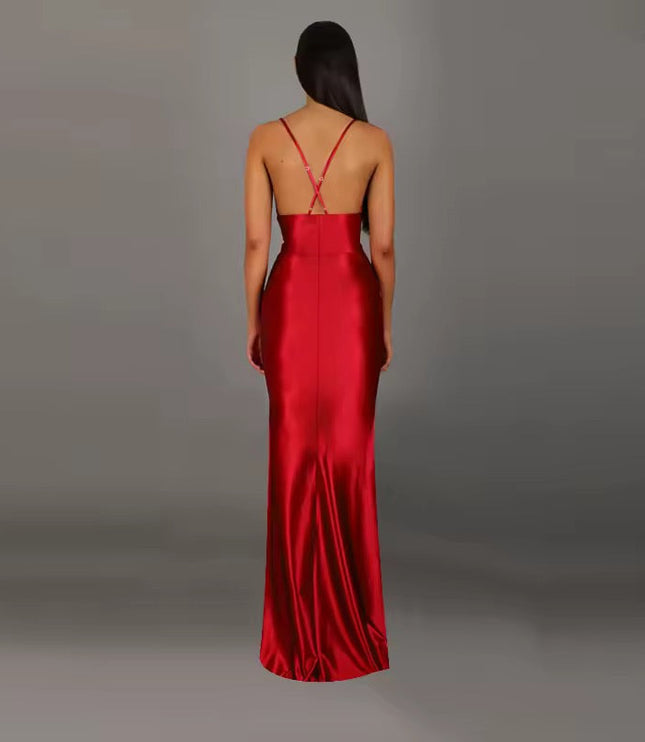 Back view of a red formal backless V-neck maxi dress, featuring delicate criss-cross straps and a floor-length skirt.