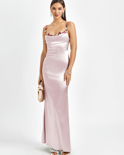 Elegant pink satin maxi dress for women, featuring a floral cowl neck, delicate straps, and a small clutch.