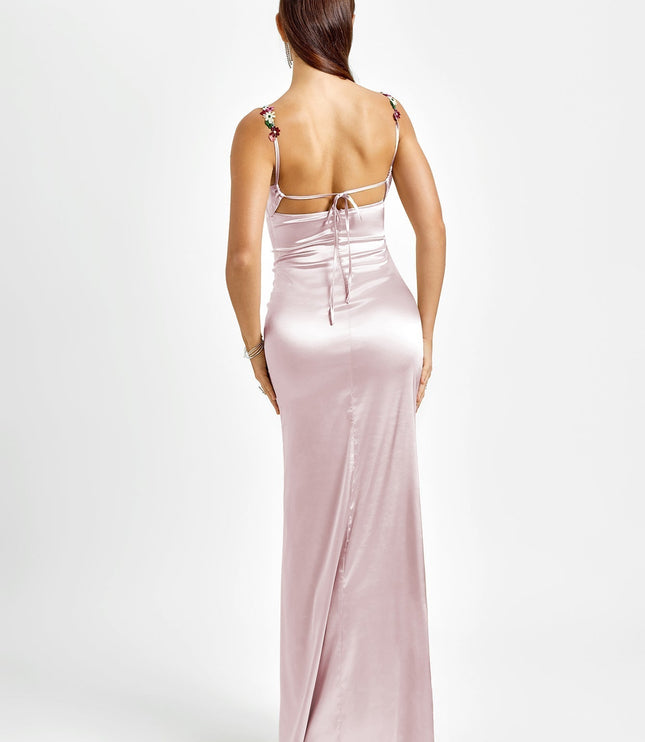 Back view of a light pink formal maxi dress with floral embroidered straps and an open back with tie details.