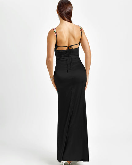 Back view of a black formal maxi dress featuring floral embroidered straps and an open back with tie closures.