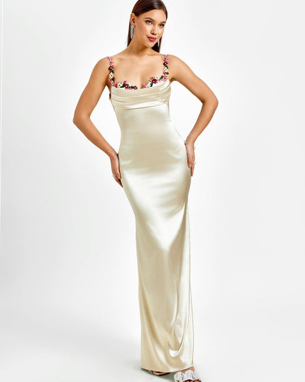 Front view of a women's formal champagne maxi dress, featuring a draped cowl neck and embroidered floral straps.