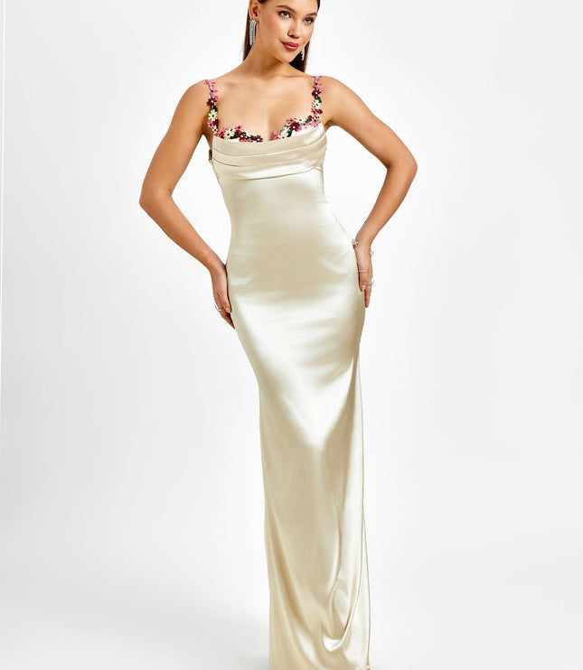 Front view of a women's formal champagne maxi dress, featuring a draped cowl neck and embroidered floral straps.