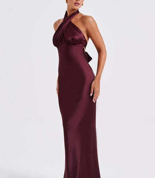 Side profile of the women's burgundy formal maxi dress, highlighting the halter neckline and body-skimming fit.