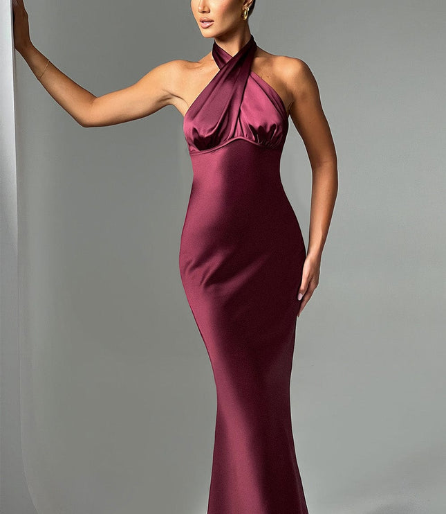 Elegant women's formal halter neck maxi dress in a rich burgundy color, featuring a fitted bodice and flowing skirt.