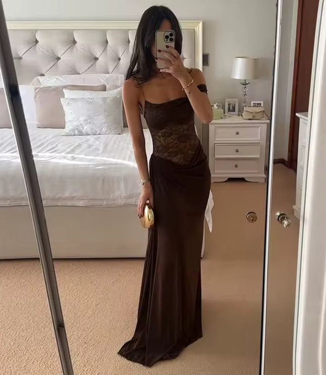 Full-length view of a woman wearing a brown off-shoulder lace corset maxi dress, holding a gold clutch.