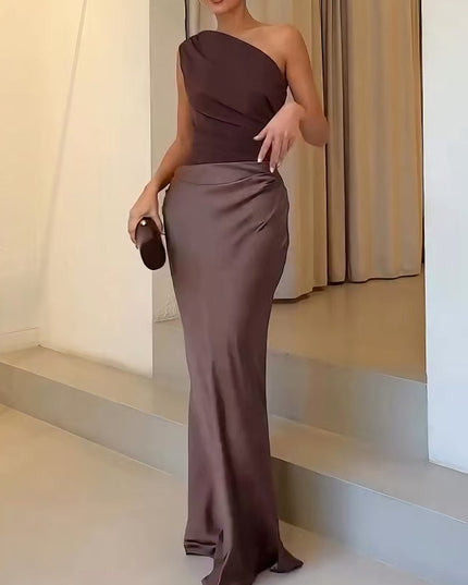 Close-up of the brown one-shoulder formal maxi dress, highlighting the gathered waist and flowing skirt fabric.