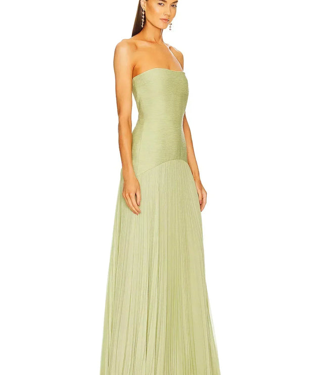 Side profile of a women's elegant light green strapless pleated maxi dress, showcasing the garment's silhouette.