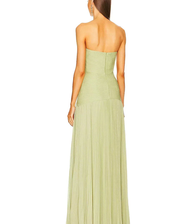 Rear view of a women's light green formal strapless maxi dress, highlighting the pleated details of the skirt.