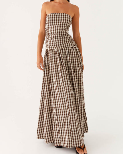 Women's brown and white gingham strapless maxi dress with ruched bodice, angled front view