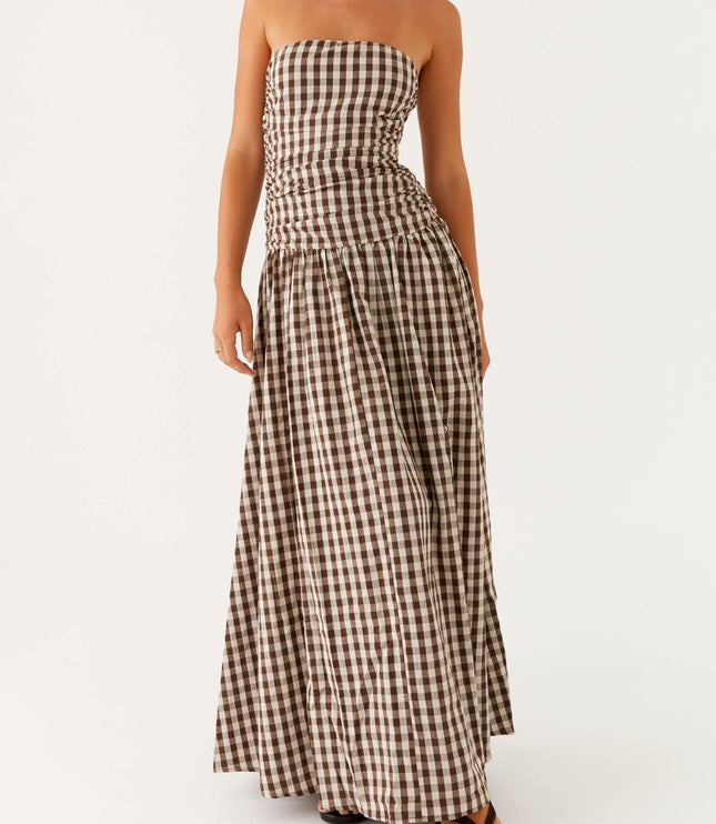 Women's brown and white gingham strapless maxi dress with ruched bodice, angled front view