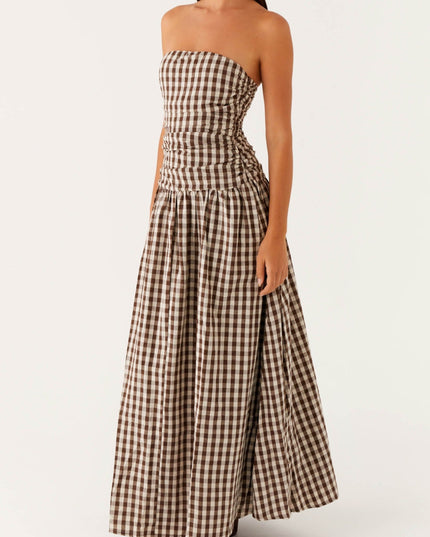 Women's brown and white gingham strapless maxi dress with ruched bodice, side view