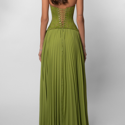 Back view of the olive green halter maxi dress, showcasing the intricate lace-up corset detail and the full pleated skirt.