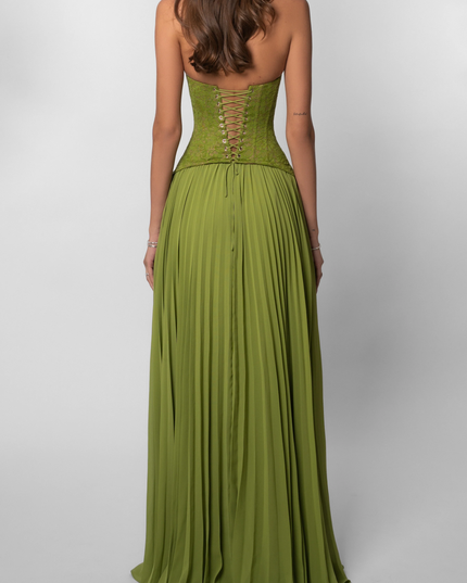 Back view of the olive green halter maxi dress, showcasing the intricate lace-up corset detail and the full pleated skirt.
