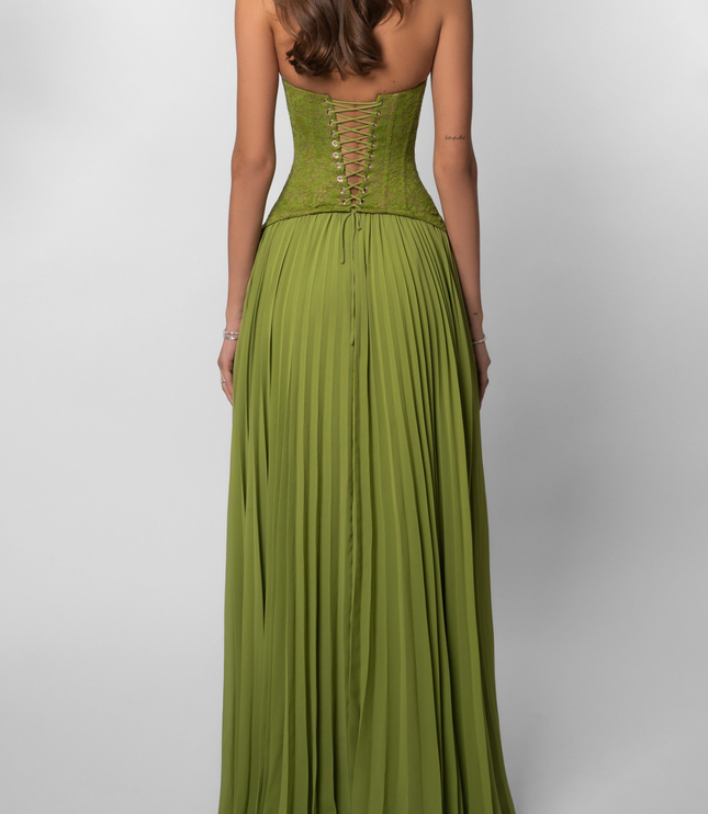 Back view of the olive green halter maxi dress, showcasing the intricate lace-up corset detail and the full pleated skirt.