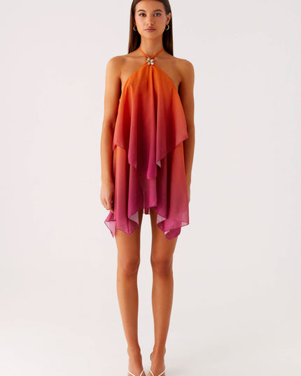 Full length front view of a women's ombre layered chiffon mini dress, showcasing the flowy style and orange to pink gradient.