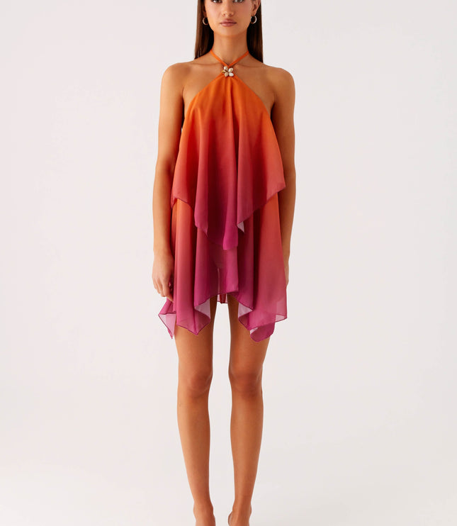 Full length front view of a women's ombre layered chiffon mini dress, showcasing the flowy style and orange to pink gradient.