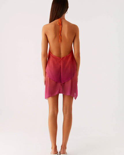 Back view of a women's halter neck ombre layered chiffon mini dress, showing the open back design and tie closure.