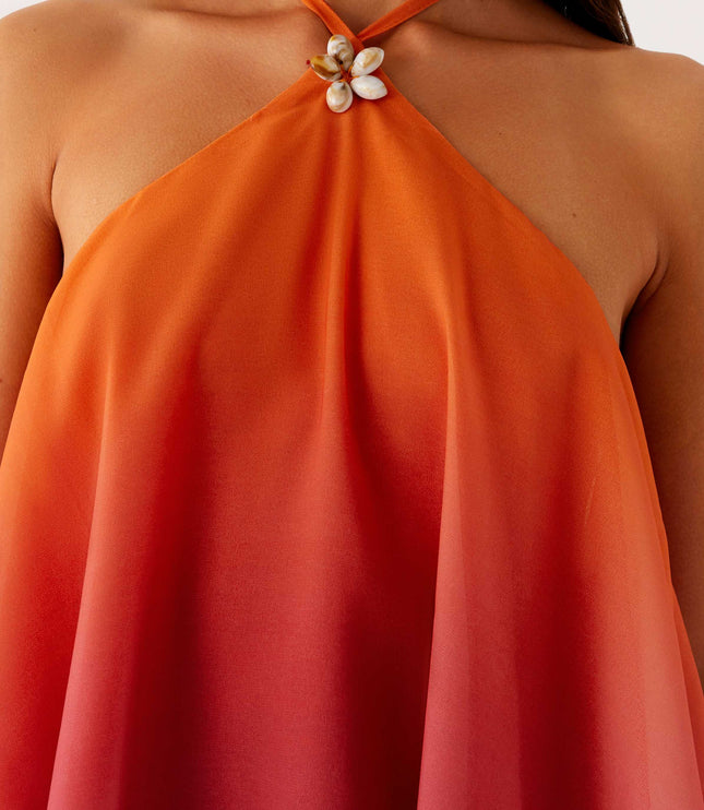 Close-up of the neckline of the ombre layered chiffon mini dress, highlighting the halter neck and decorative shell detail.