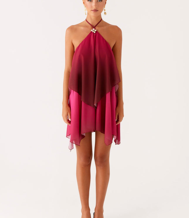 Full length front view of a women's layered chiffon mini dress, featuring a deep burgundy to fuchsia ombre and a shell detail.