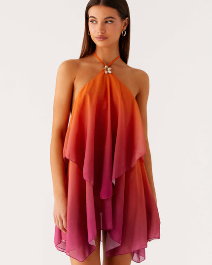 Front view of a women's halter neck ombre layered chiffon mini dress, fading from orange to pink, with a shell detail at the neckline.
