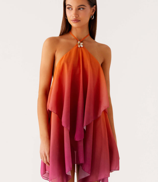 Front view of a women's halter neck ombre layered chiffon mini dress, fading from orange to pink, with a shell detail at the neckline.