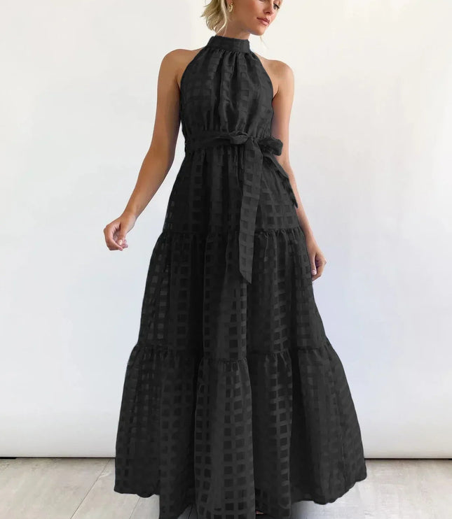 Elegant black halter neck tiered maxi dress, featuring a subtle checkered pattern and a matching waist tie.