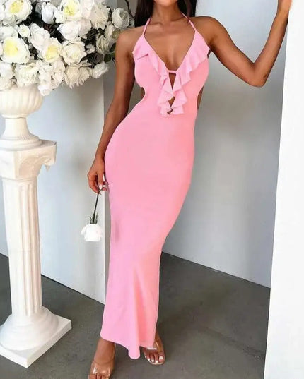 Full length view of a pink halter ruffle cut out backless maxi dress, showcasing the elegant fit and ruffles.