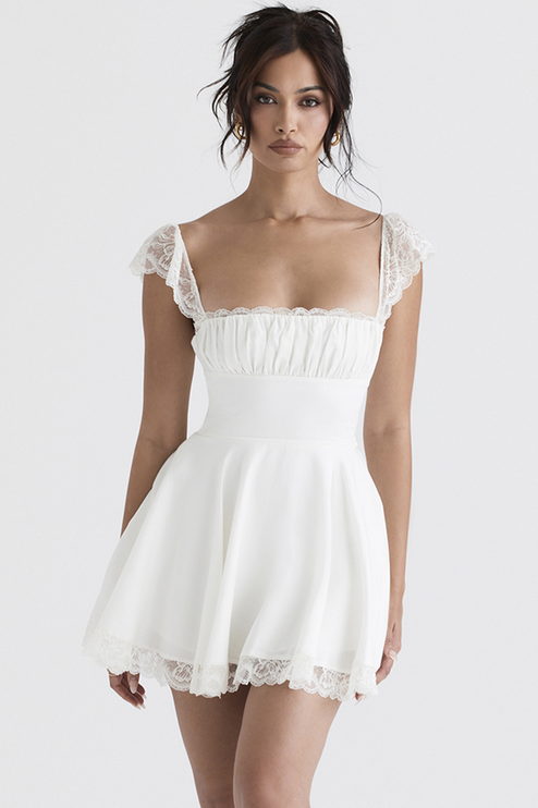 Full-length front view of a white mini dress with delicate lace cap sleeves and a square neckline, showcasing the fitted bodice and flowing skirt.