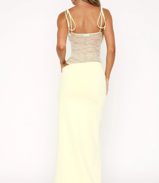 Back view of a pale yellow women's lace panel maxi dress with spaghetti straps and a square neckline, showing the full length.