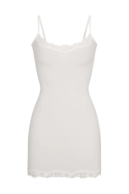 White women's lace trim scoop neck mini slip dress, showcasing the intricate lace along the neckline and hem.