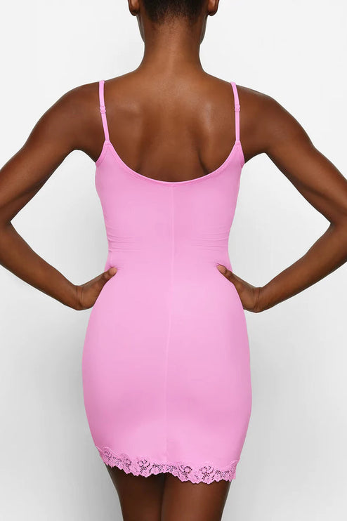Rear close-up of the pink lace trim mini slip dress, emphasizing the scoop back design and lace hem detail.