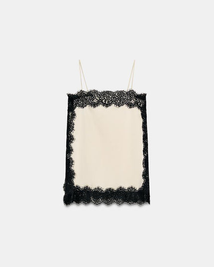 Flat lay of a cream satin camisole mini dress, showcasing the square neck and black lace trim on all edges.