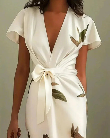 Close-up front view of the white leaf print v-neck short sleeve midi wrap dress, showing the tied waist detail.