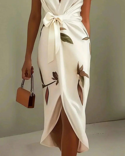 Side view of a women's white leaf print v-neck short sleeve midi wrap dress, showcasing the flowy skirt and purse.
