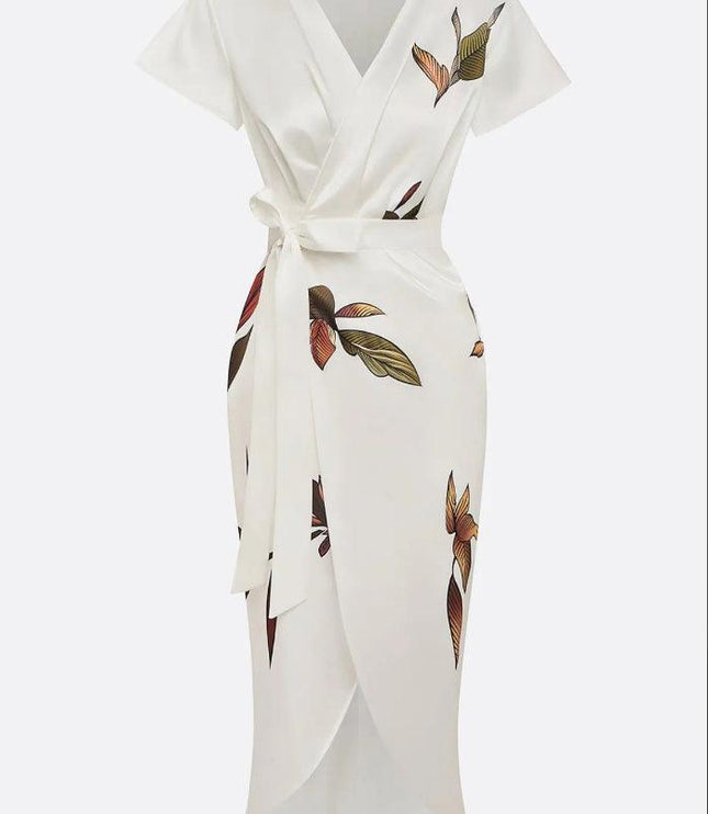 Studio shot of the white leaf print v-neck short sleeve midi wrap dress, displaying the full garment on a hanger.
