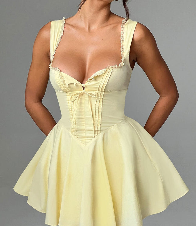 Front detail of the lemon yellow pintuck mini dress, showing the sweetheart neckline and structured bodice.