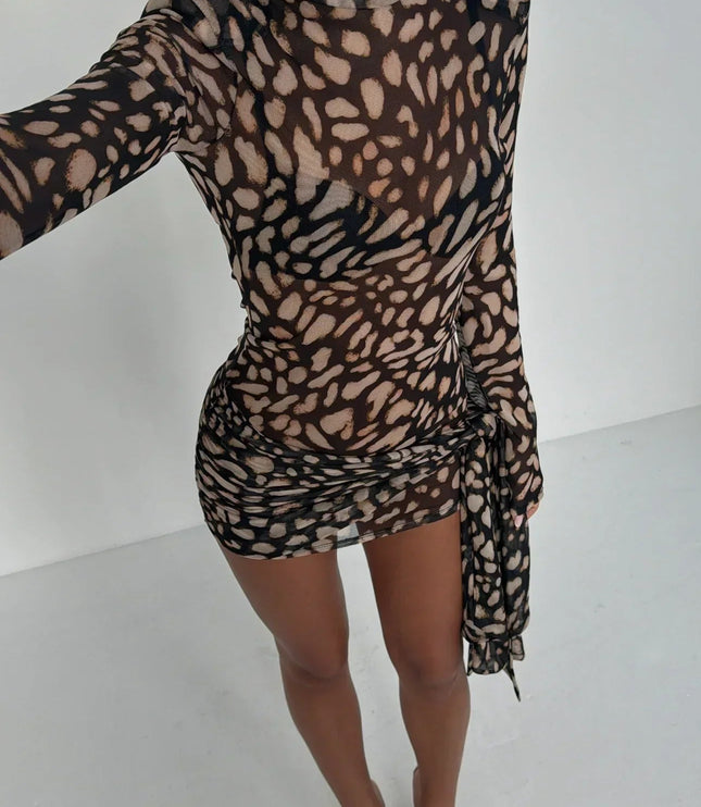 Overhead view of women's leopard print high neck ruched mini dress, showcasing sheer fabric and print.