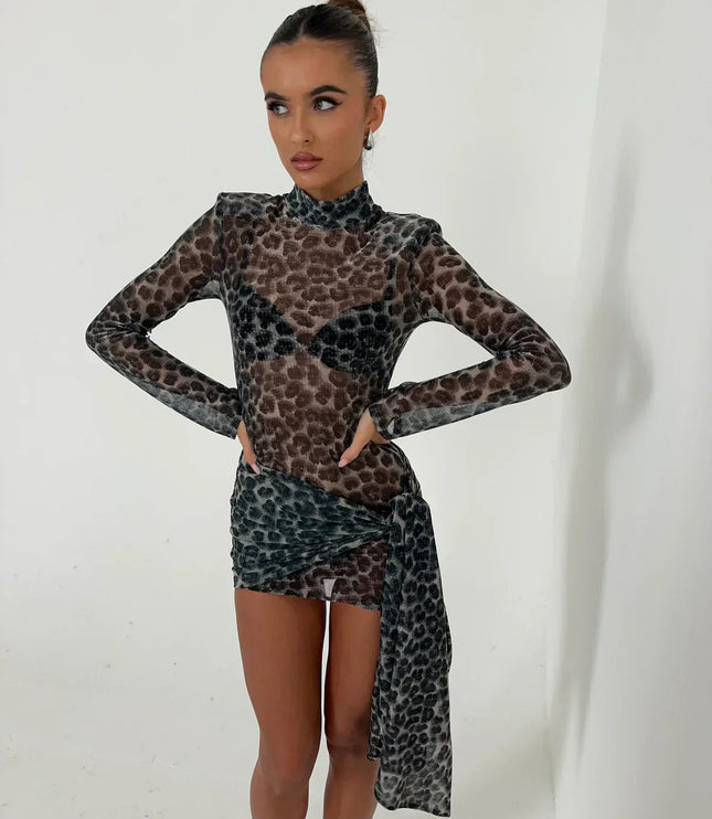 Front view of women's dark leopard print high neck ruched mini dress with long sleeves, hands on hips.