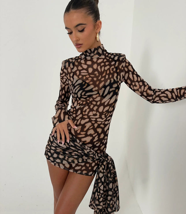 Women's leopard print high neck ruched mini dress with long sleeves and cascading fabric detail, side view.