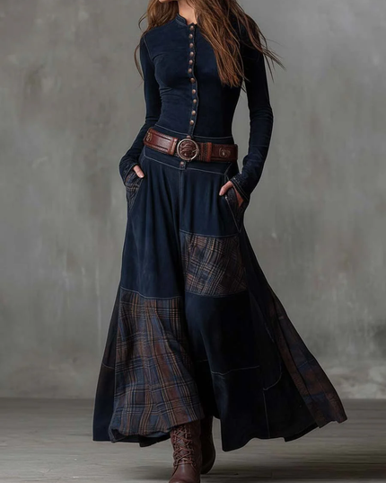 Full view of the women's dark blue long sleeve button down plaid maxi dress, styled with a brown belt.